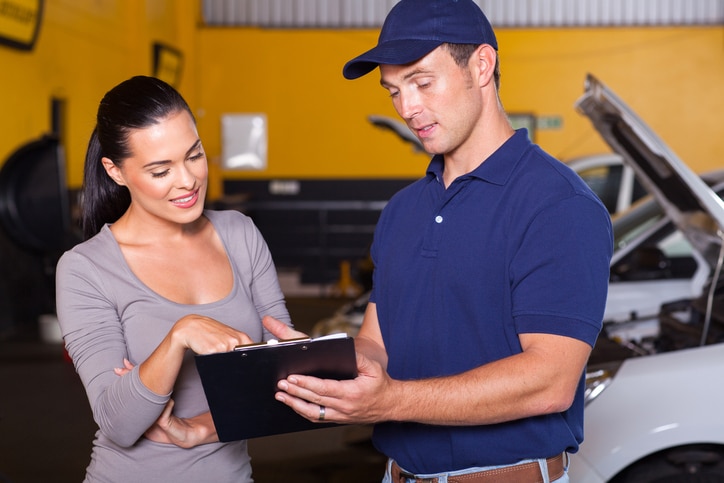 auto mechanic and female customer in garage